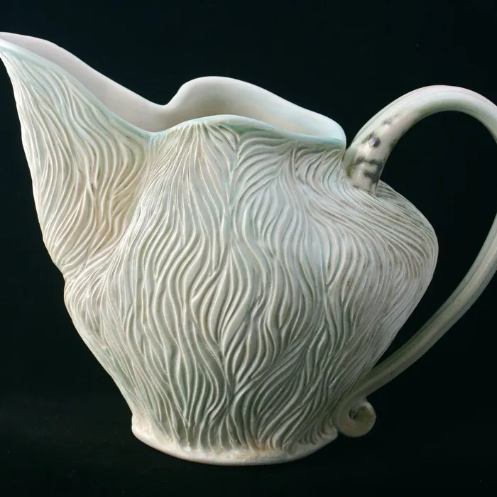 Carved pitcher, chameleon.