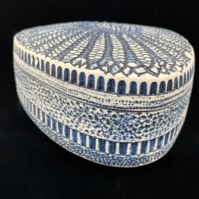 Triangular diatom sculpture with cobalt oxide wash